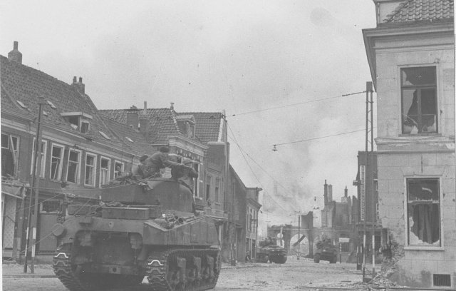 Canadian tank firing at buildings on the rademark in Groningen during the Battle of Groningen.
